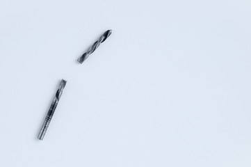 Broken metal drill bit for drill on white background. Tools and repairs.