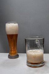 Closeup of pouring gold beer two on grey background for concept design. Summer concept.