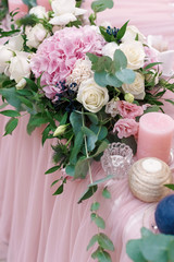 Original wedding floristics closeup. The wedding flower bouquet is supplemented with rose hortensia, roses and greenery. Floral background