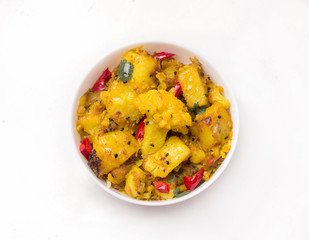 Indian traditional cuisine. gobi aloo vegetarian vegetable dish on a white background.