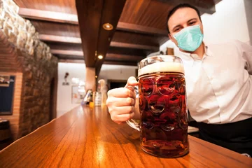 Foto op Plexiglas Kroeg Gemaskerde barman die een gigantisch biertje serveert