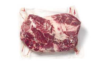 piece of Fresh pork meat in vacuum packed. Vacuum packed raw fresh pork neck meat isolated on white