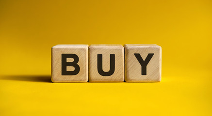 BUY text on a yellow background on wooden cubes