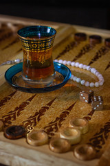 Board games of backgammon. Armudu glass tea cup and board details and chips. The ancient game of the East and Asia. Relax and have fun with friends.