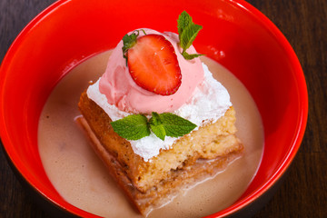 Cake with ice cream served stravberry