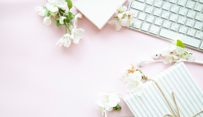 pink office desk with smartphone with blank screen mockup, laptop computer, cup of coffee and supplies. Top view with copy space, flat lay.