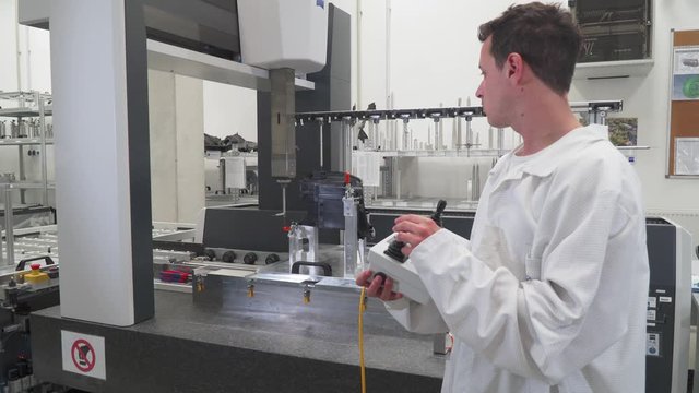quality engineer control using remote control machine for accurate 3d measurement of plastic castings, headlight production for the automotive industry