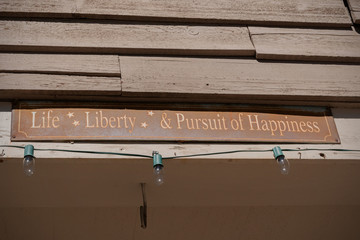 A rusty old sign in the USA showing Life Liberty & Pursuit of Happiness © David Pimborough