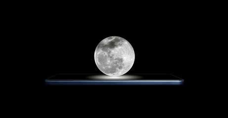 Creative 3D photo of a modern smartphone and a full moon hanging above it, isolated on a black background. Full moon hanging over a modern mobile phone.