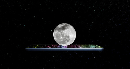 Creative 3D photo of a modern smartphone and a full moon hanging above it, soaring in space with...