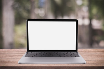 Blank screen laptop computer on wood table top with coffee shop bokeh background, 3D rendering