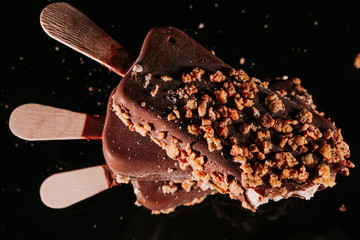 .Close up of colorful ice cream. Chocolate ice cream on a stick. Tasty dessert. Popsicle.