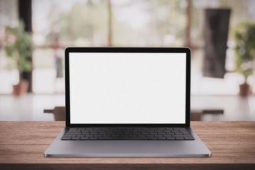 Blank screen laptop computer on wood table top with coffee shop bokeh background, 3D rendering