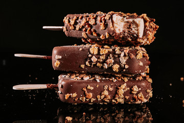 .Close up of colorful ice cream. Chocolate ice cream on a stick. Tasty dessert. Popsicle.