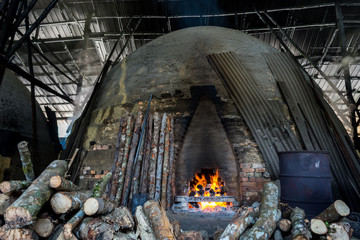 traditional charcoal kiln with charcoal under production with mangrove (Rhizophora sp) wood