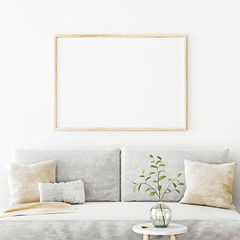 Poster mockup with horizontal frame hanging on the wall in living room interior with sofa, beige pillows and green branch in glass vase on empty white background. 3D rendering, illustration.