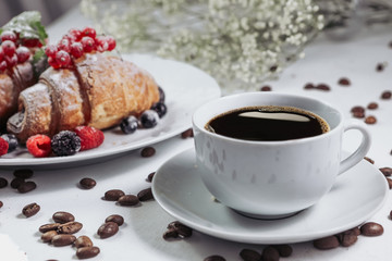 .French breakfast, great design for any purpose. Sweet food. Healthy breakfast. View from above. Aesthetic look. Raspberries, currants and blackberries. Coffee beans in bulk. Hot and aromatic coffee