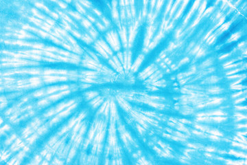 spiral tie dye pattern hand dyed on cotton fabric abstract texture background.