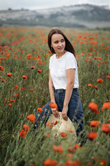 Romantic girl at sunset in poppy field - 345997282