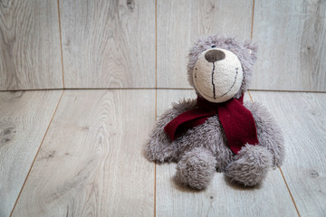 Soft teddy bear on a wooden background