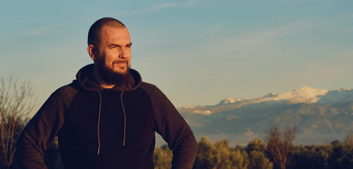 Man pose against Sierra Nevada mountains background. Spain