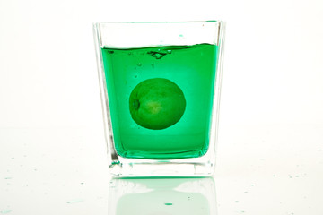 glass of lime cocktail with lemon