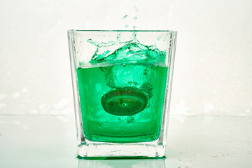glass of green water with orange
