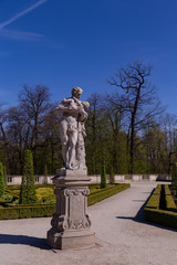 statue of a man with a child in Wilanowski Park Poland on a sunny day
