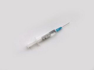 Syringe for medicine on a light gray background. Disease treatment. The fight against coronavirus 2020.