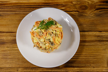 Tasty salad with chicken breast, roasted mushrooms, carrots, grated cheese, eggs and mayonnaise on...