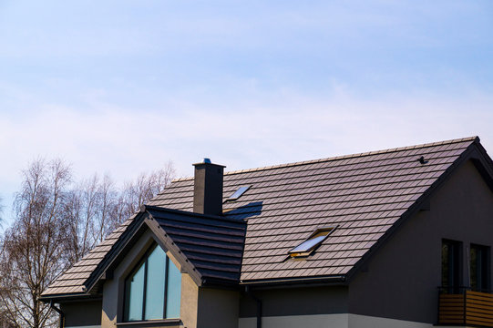 A newly built house. The roof is made of ceramic tiles.