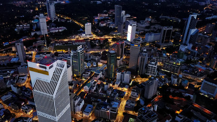 Aerial view of city skyline at the developed corporative area of Kuala Lumpur in Malaysia, skyscrapers, lights on streets during the night. 