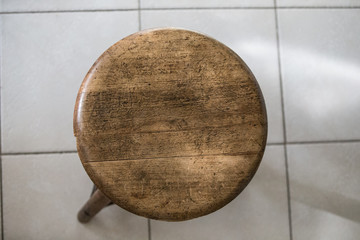 Wooden stool on the tiled floor.