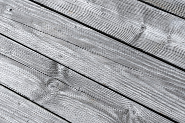 Close-up of rustic textured gray wood planks in diagonal rows