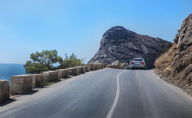 Car rides on the road along the sea