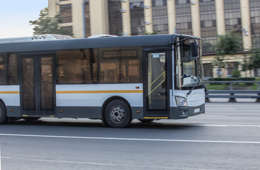 Fototapeta na wymiar bus rides along the street in the city