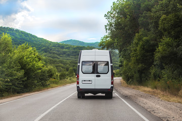 Fototapeta na wymiar Minibus rides on a mountain road