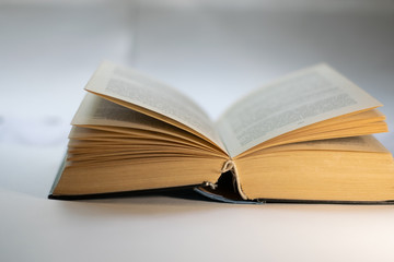 thick open book on a white background
