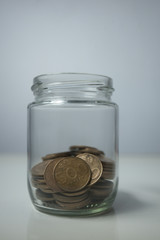 coins in a transparent bottle or jar