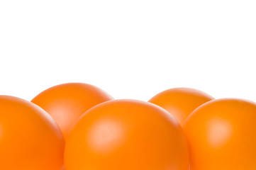Bunch of fresh ripe orange tomatoes isolated on white background. Studio shot