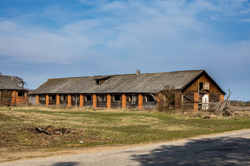 Abandoned ruined barn cowshed outside view 