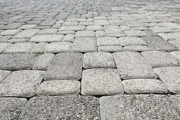 Road paved with gray square road tiles