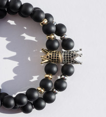 Stock Photo - bracelet with little crown on white