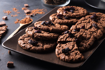 traditional freshly baked chocolate cookies on a black background close-up. quick snack