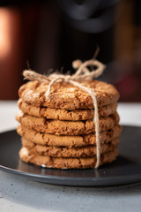 traditional freshly baked chocolate cookies, glass of milk on a black background close-up. quick snack