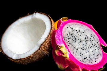 Arrangement with fruits on a shiny black surface with black background.