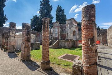Columns in front of the Temple of Isis in ancient Pompeii, Italy - obrazy, fototapety, plakaty