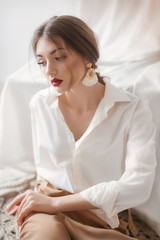 Portrait of beautiful young woman with makeup in fashion clothes