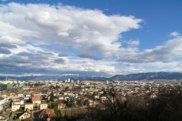 Sunrise and sunset, beautiful clouds over the meadow, hills and buildings in the town. Slovakia