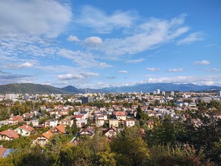 Fototapeta premium Sunrise and sunset, beautiful clouds over the meadow, hills and buildings in the town. Slovakia